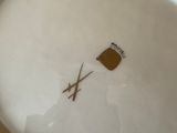 a white plate with a brown design on it