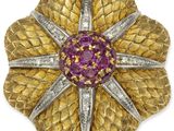 a gold and diamond flower broochle, by van cleef