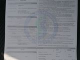 a sheet of paper with information on it sitting on a car seat