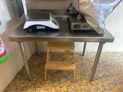 a small table with a chair and a microwave on it