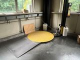 a yellow table in a room with a lot of windows