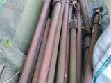 a pile of old rusty pipes sitting on the ground