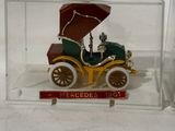 a small toy car with an umbrella in a clear box
