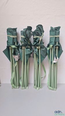 four vases with flowers in them sitting on a table