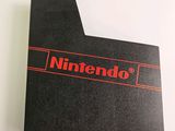 a close up of a nintendo logo on a black folder