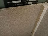 a pile of wood in a room with a sign on the wall