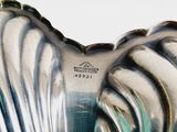 a glass vase that has a heart shaped design on it