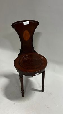 an antique wooden chair with a carved seat and back rest