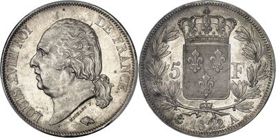 a silver coin with a crown on top of it