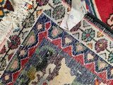 a close up of a rug with a tag on it