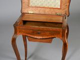 a small wooden desk with a drawer on it