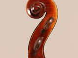 an antique violin with a scroll on the back of it