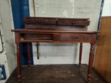 a wooden desk with two drawers on top of it