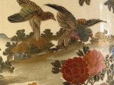 a vase with a bird and flowers painted on it
