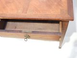 a small wooden table with a drawer underneath it