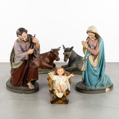three figurines of jesus and a baby jesus in a manger