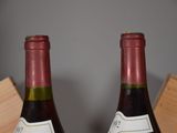 two bottles of wine that are sitting on a table
