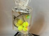 tennis balls in a clear plastic bag with a black base