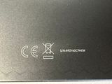 a close up of a black box with a white logo on it