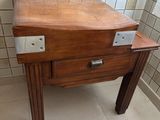a wooden table with a drawer on it in a bathroom
