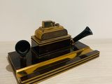 a black and gold cigarette holder with a pipe on top of it