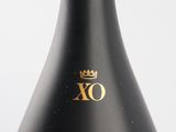a black bottle with a gold xo logo on it