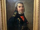 tableau représentant un homme en uniforme militaire, dans un cadre doré