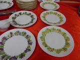 many plates on a table with a red table cloth