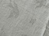 a close up of a white table cloth with a flower design on it