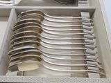 a lot of spoons and forks in a box