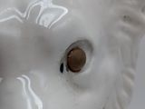 a close up of a ceramic animal head on a table