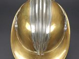 an image of a gold and silver fire helmet on a black background