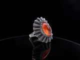an image of a ring with a red stone in it