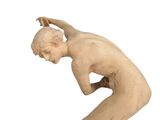 statue of a man kneeling on his knees holding a tennis racket