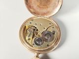 a gold pocket watch with a chain attached to it