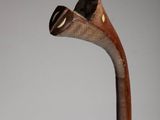 an image of a wooden walking stick with a hat on top of it