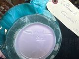 a blue vase with a tag on it sitting on a table