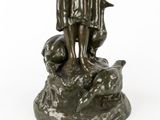 bronze statue of a boy with a dog on a rock