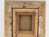 a picture of a wooden frame hanging on the wall