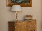 a painting on the wall next to a dresser in a living room