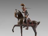 statue of a man riding a horse with a sword on its back