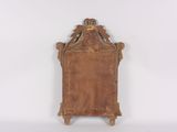 an old wooden mirror sitting on top of a white wall