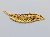 an image of a gold plated leaf pendant on a white background