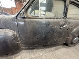 an old car that is sitting in a garage