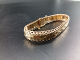 bracelet on a table with a black surface and a white background