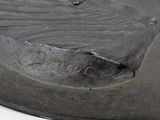 a close up of a metal object on a white surface