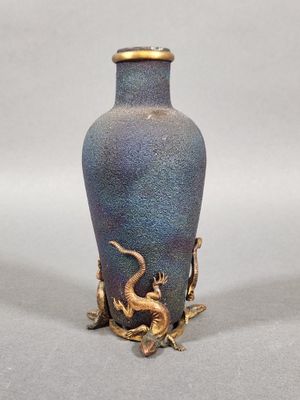 a blue vase with a gold dragon on it