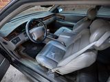 the interior of a car with leather seats and a steering wheel