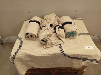 a bed with towels and blankets on it in a room