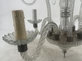 a glass chandelier with a candle holder attached to it